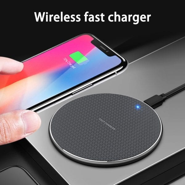 Wireless fast charger with a smartphone on a black background