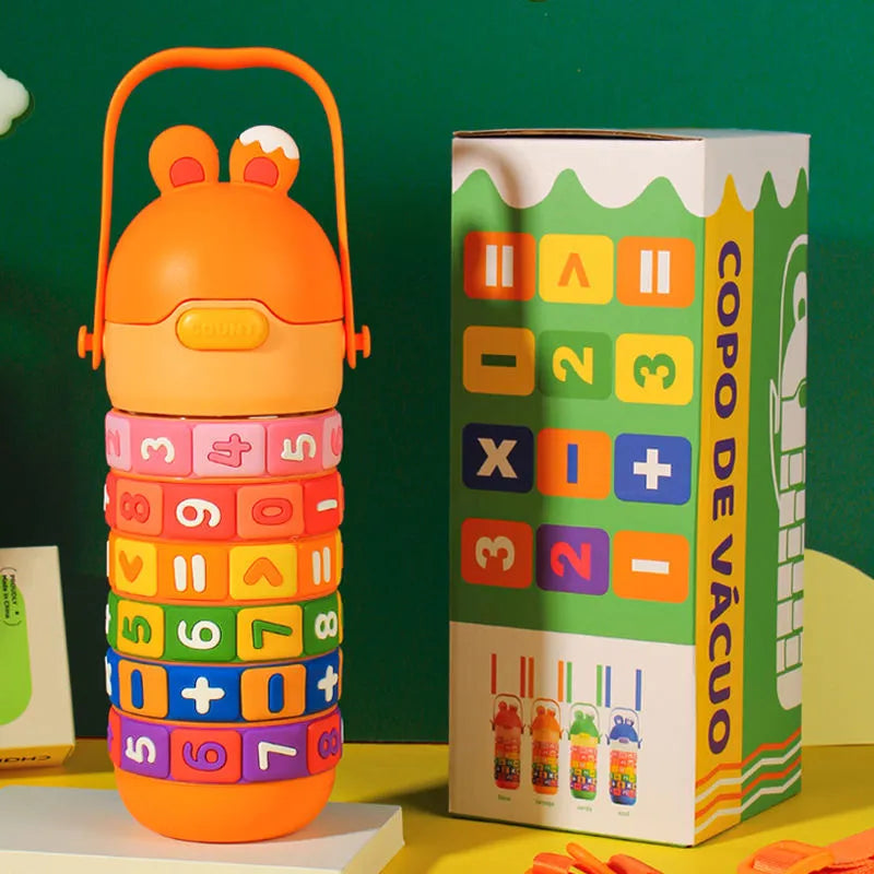 Colorful stackable cup with numbers and letters next to its packaging on a green background